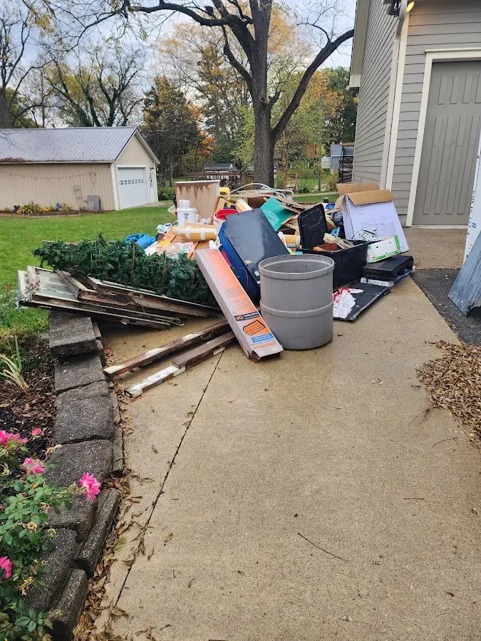 Dumpster being loaded with debris for Commercial Dumpster Rental in Egg Harbor